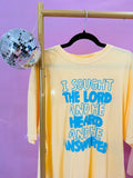 Buttery yellow shirt with blue puff lettering that says “I sought the Lord, He heard, and He answered” Christian graphic tee