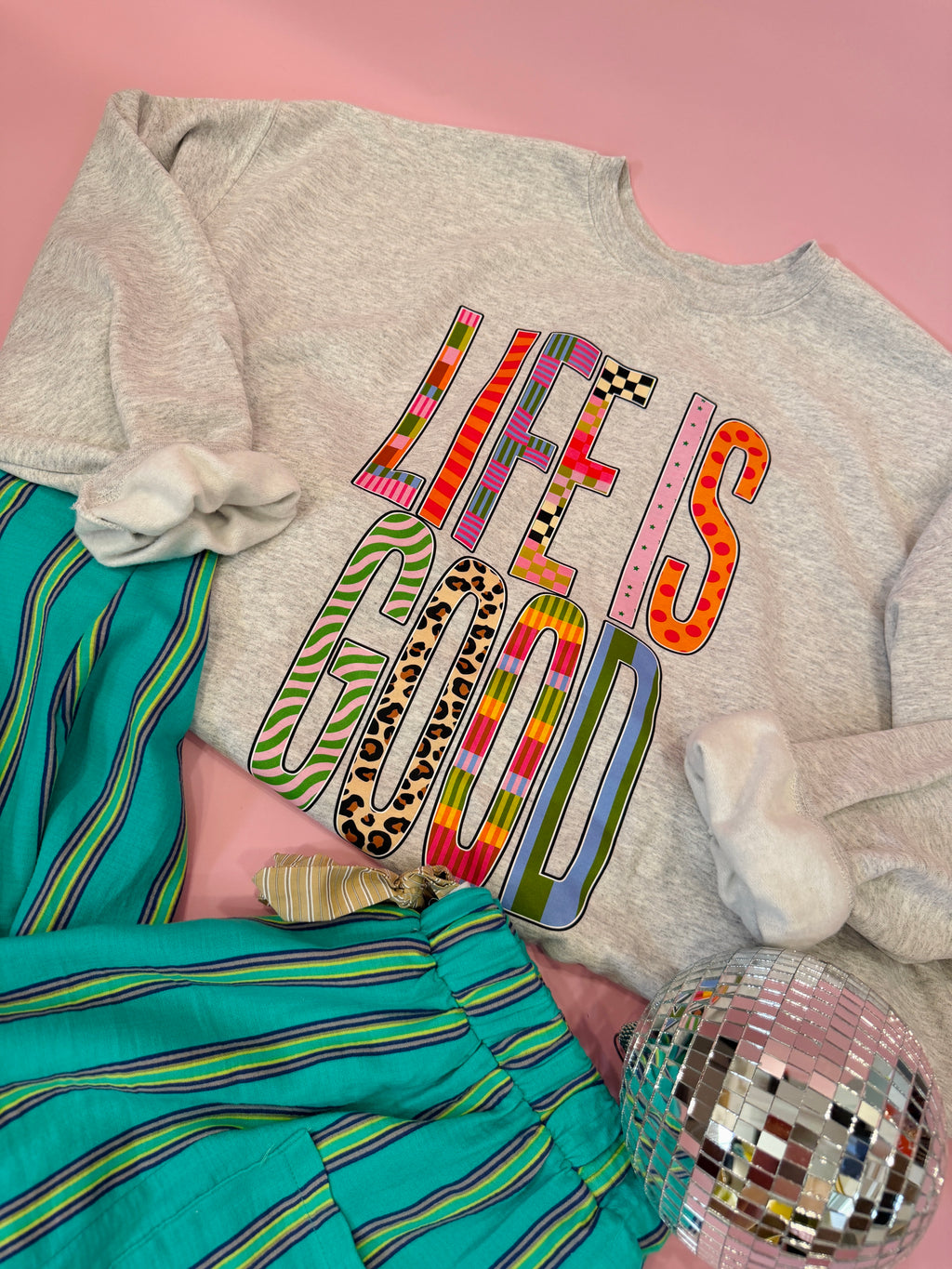 Gray sweatshirt with colorful patchwork “Life Is Good” graphic design for women