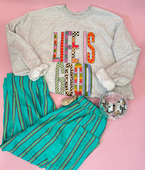 Teal barrel pants with green and pinkish purple striped pattern, bold boutique style bottoms